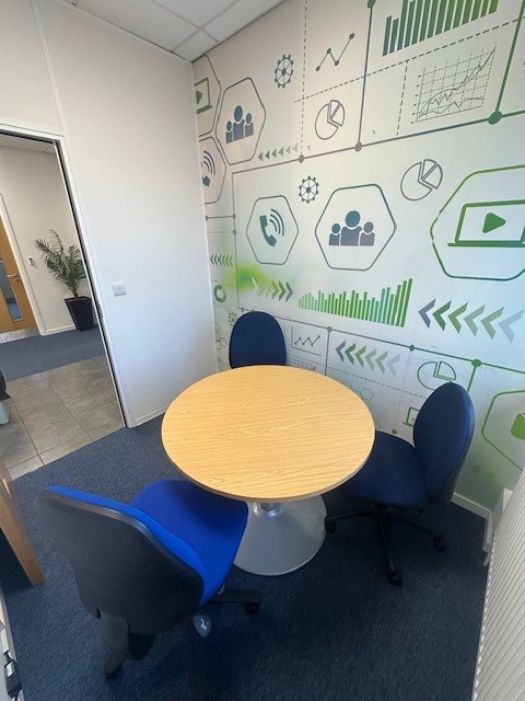 Three chairs around a round table in the small meeting room at Maylands Business Centre