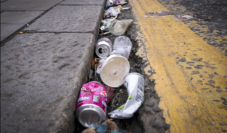 Example of littering Cans and cups strewn in the gutter on a road