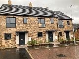 Exterior of three new homes and parking spaces in Douglas Terrace