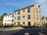 Outside of Randalls Ride apartments with car parking spaces and garden