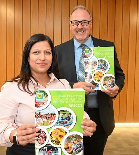 Two Councillors holding a copy of the new corporate plan